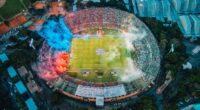 Aerial View of Stadium with Blue and Red Smoke