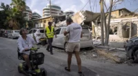 Sun., Oct. 8: Israelis inspect the rubble of a building a day after it was hit by a rocket fired from the Gaza Strip, in Tel Aviv, Israel. Oded Balilty/AP
