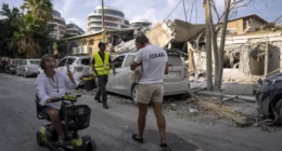 Sun., Oct. 8: Israelis inspect the rubble of a building a day after it was hit by a rocket fired from the Gaza Strip, in Tel Aviv, Israel. Oded Balilty/AP