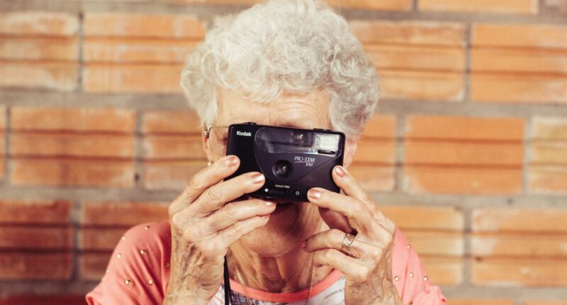woman holding film camera