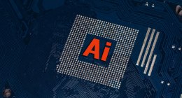 Chip de computadora sobre una placa de circuitos azul, con el texto 'Ai' en rojo sobre el procesador