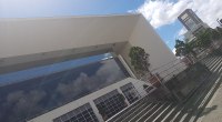 Edificio cultural de concreto y vidrio en Pereira, con escaleras y un edificio alto al fondo